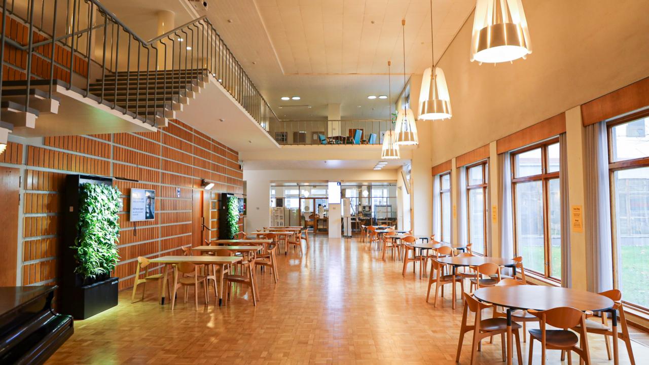 Hanken's foyer: tables and a staircase going up to the second floor.