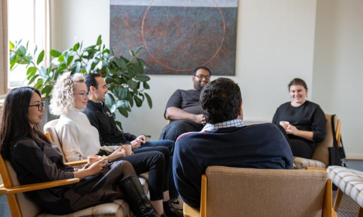 Six people sitting around a table